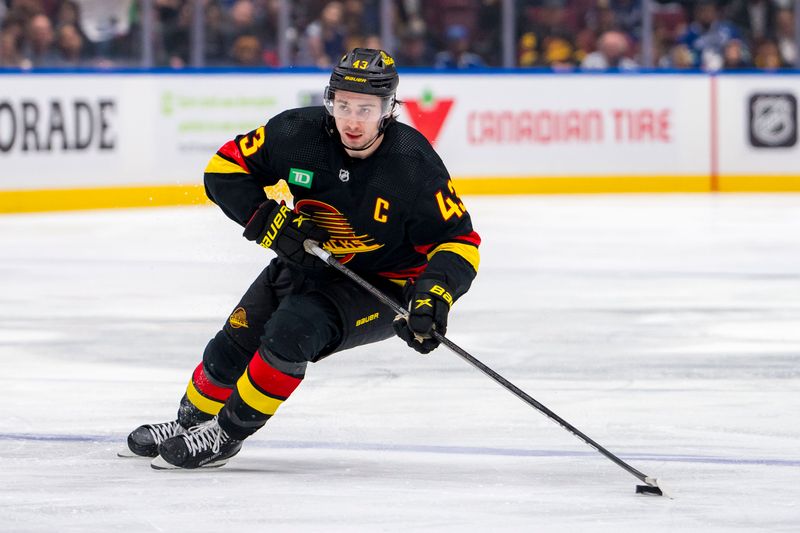 Mar 25, 2024; Vancouver, British Columbia, CAN; Vancouver Canucks defenseman Quinn Hughes (43) handles the puck against the Los Angeles Kings in the third period at Rogers Arena. Kings won 3 -2. Mandatory Credit: Bob Frid-USA TODAY Sports