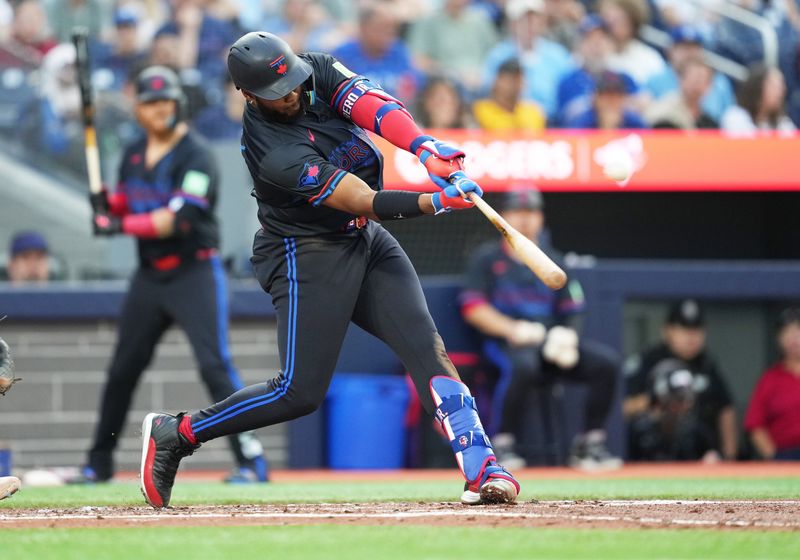 Jul 24, 2024; Toronto, Ontario, CAN; Toronto Blue Jays first baseman Vladimir Guerrero Jr. (27) hits a home run against the Tampa Bay Rays during the third inning at Rogers Centre. Mandatory Credit: Nick Turchiaro-USA TODAY Sports