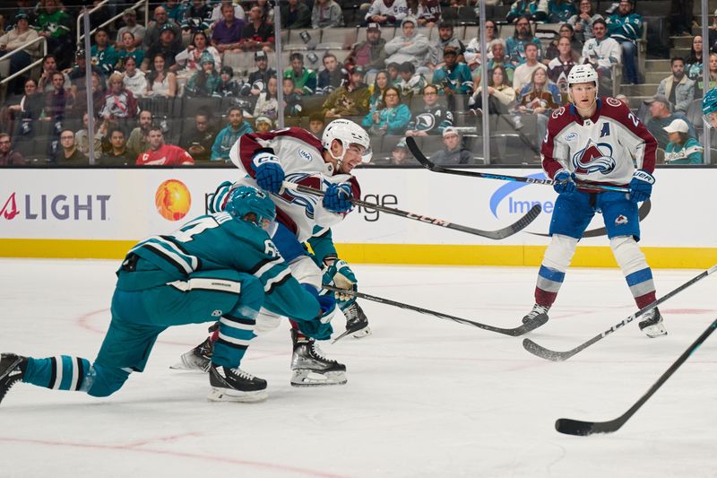 Oct 20, 2024; San Jose, California, USA; Colorado Avalanche center Ross Colton (20) shoots the puck and scores a goal against the San Jose Sharks during the first period at San Jose. Mandatory Credit: Robert Edwards-Imagn Images