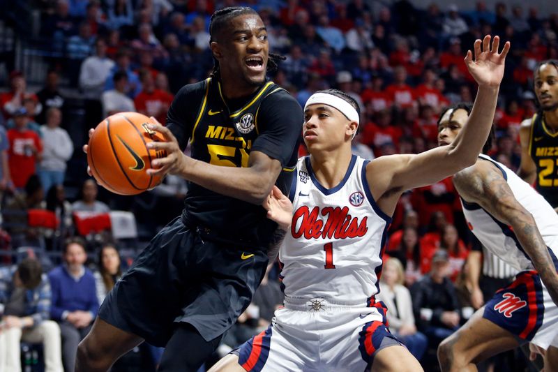 Feb 17, 2024; Oxford, Mississippi, USA; Missouri Tigers guard Sean East II (55) drives to the basket as Mississippi Rebels guard Austin Nunez (1) defends during the first half at The Sandy and John Black Pavilion at Ole Miss. Mandatory Credit: Petre Thomas-USA TODAY Sports