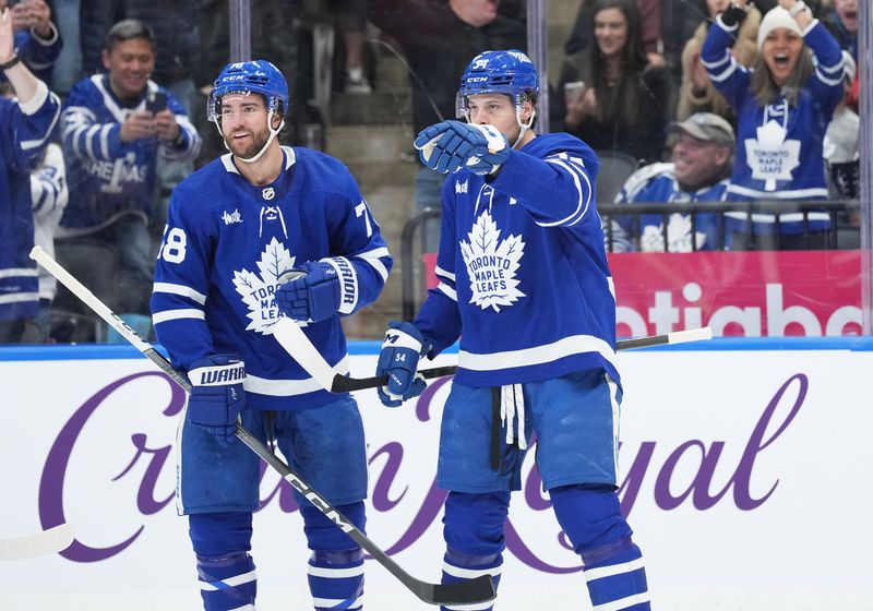 Feb 17, 2024; Toronto, Ontario, CAN; Toronto Maple Leafs center Auston Matthews (34) scores a goal and celebrates with defenseman TJ Brodie (78) against the Anaheim Ducks during the first period at Scotiabank Arena. Mandatory Credit: Nick Turchiaro-USA TODAY Sports