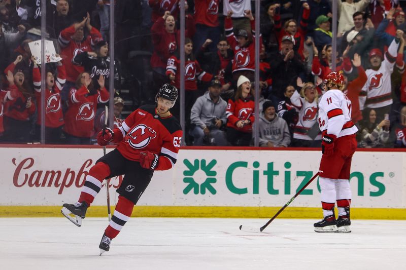 Nov 21, 2024; Newark, New Jersey, USA; New Jersey Devils left wing Jesper Bratt (63) celebrates his goal against the Carolina Hurricanes during the third period at Prudential Center. Mandatory Credit: Ed Mulholland-Imagn Images