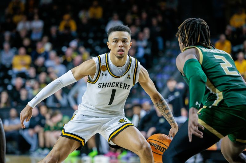 Feb 27, 2025; Wichita, Kansas, USA; Wichita State Shockers guard Xavier Bell (1) brings the ball up court around UAB Blazers guard Ja'Borri McGhee (2) during the second half at Charles Koch Arena. Mandatory Credit: William Purnell-Imagn Images