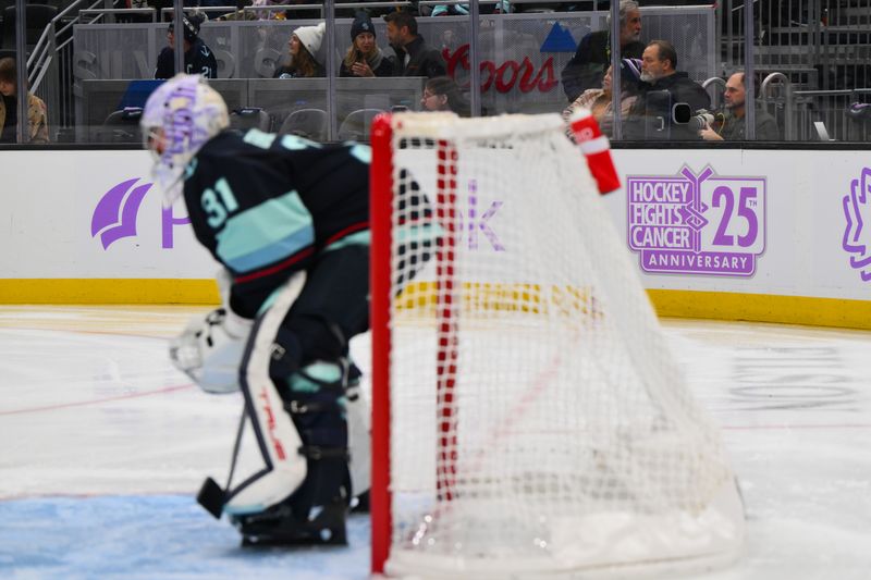 Nov 16, 2023; Seattle, Washington, USA; Hockey Fights Cancer signaged during the second between the Seattle Kraken and the New York Islanders period at Climate Pledge Arena. Mandatory Credit: Steven Bisig-USA TODAY Sports