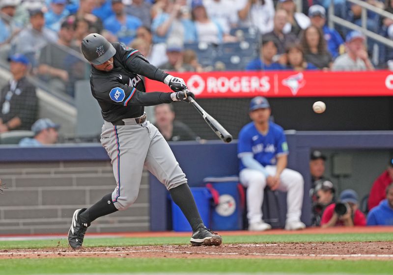 Sep 29, 2024; Toronto, Ontario, CAN; Miami Marlins shortstop Xavier Edwards (63) hits a single against the Toronto Blue Jays during the fifth inning at Rogers Centre. Mandatory Credit: Nick Turchiaro-Imagn Images