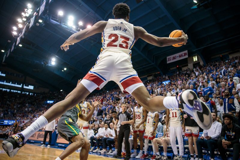 Feb 18, 2023; Lawrence, Kansas, USA; Kansas Jayhawks center Ernest Udeh Jr. (23) leaps to save a ball from going out of bands during the second half against the Baylor Bears at Allen Fieldhouse. Mandatory Credit: William Purnell-USA TODAY Sports