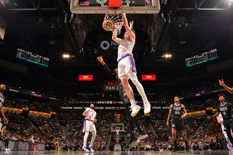 SAN ANTONIO, TX - NOVEMBER 15: Dalton Knecht #4 of the Los Angeles Lakers dunks the ball during the game against the San Antonio Spurs during the Emirates NBA Cup game on November 15, 2024 at the Frost Bank Center in San Antonio, Texas. NOTE TO USER: User expressly acknowledges and agrees that, by downloading and or using this photograph, user is consenting to the terms and conditions of the Getty Images License Agreement. Mandatory Copyright Notice: Copyright 2024 NBAE (Photos by Jesse D. Garrabrant/NBAE via Getty Images)