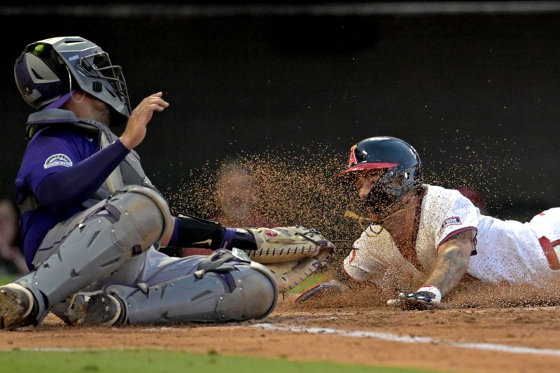 Jul 30, 2024; Anaheim, California, USA;  Los Angeles Angels shortstop Zach Neto (9) beats the tag by Colorado Rockies catcher Elias Diaz (35) for a run in the third inning at Angel Stadium. Mandatory Credit: Jayne Kamin-Oncea-USA TODAY Sports