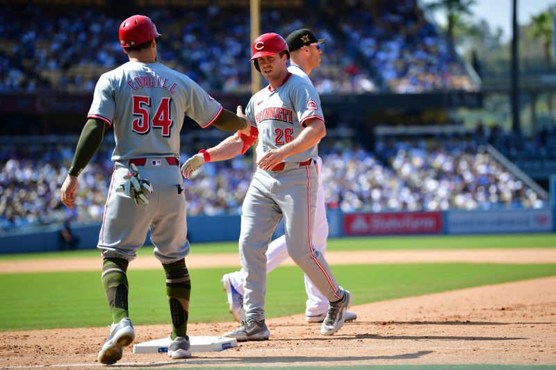 May 19, 2024; Los Angeles, California, USA; Cincinnati Reds outfielder Jacob Hurtubise (26) is greeted by first base coach Collin Cowgill (54) after hitting a single against the Los Angeles Dodgers during the ninth inning at Dodger Stadium. Mandatory Credit: Gary A. Vasquez-USA TODAY Sports