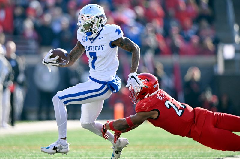 Nov 25, 2023; Louisville, Kentucky, USA;  Kentucky Wildcats wide receiver Barion Brown (7) avoids the tackle of Louisville Cardinals defensive back Devin Neal (27) during the second half at L&N Federal Credit Union Stadium. Kentucky defeated Louisville 38-31. Mandatory Credit: Jamie Rhodes-USA TODAY Sports