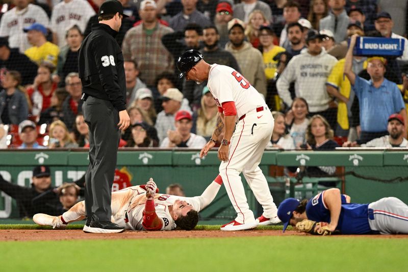 May 7, 2025; Boston, Massachusetts, USA; Boston Red Sox first baseman Romy Gonzalez (23) reacts after a collision with Texas Rangers third baseman Josh Smith (8) during the sixth inning at Fenway Park. Mandatory Credit: Brian Fluharty-Imagn Images