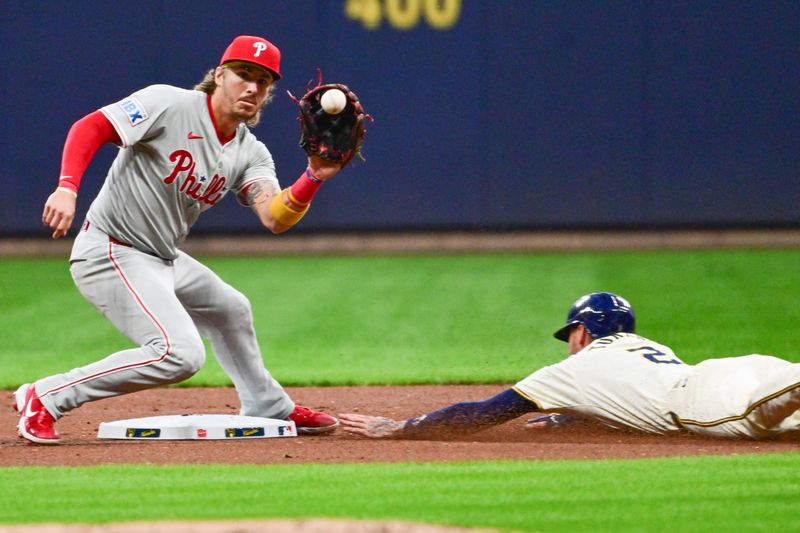 Sep 18, 2024; Milwaukee, Wisconsin, USA; Milwaukee Brewers second baseman Brice Turang (2) steals second base as Philadelphia Phillies second baseman Bryson Stott (5) takes the throw in the first inning at American Family Field. Mandatory Credit: Benny Sieu-Imagn Images