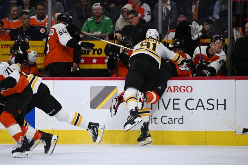 Nov 2, 2024; Philadelphia, Pennsylvania, USA; Boston Bruins defenseman Nikita Zadorov (91) hits Philadelphia Flyers center Morgan Frost (48) in the first period at Wells Fargo Center. Mandatory Credit: Kyle Ross-Imagn Images