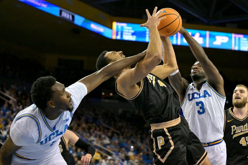 Jan 20, 2026; Los Angeles, California, USA;  Purdue Boilermakers forward Trey Kaufman-Renn (4), UCLA Bruins forward Xavier Booker (1) and guard Eric Dailey Jr. (3) battle for a rebound in the first half at Pauley Pavilion presented by Wescom Financial. Mandatory Credit: Jayne Kamin-Oncea-Imagn Images