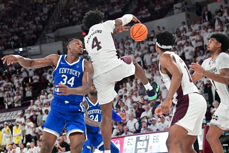 Feb 15, 2023; Starkville, Mississippi, USA; Mississippi State Bulldogs guard Cameron Matthews (4) and Kentucky Wildcats forward Oscar Tshiebwe (34) battle for the ball during the second half at Humphrey Coliseum. Mandatory Credit: Matt Bush-USA TODAY Sports