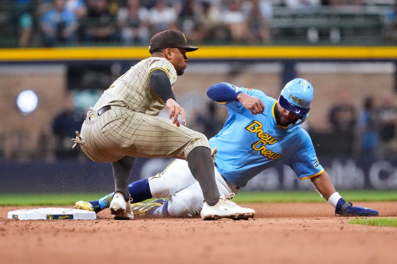 Jun 6, 2025; Milwaukee, Wisconsin, USA;  Milwaukee Brewers center fielder Jackson Chourio (11) steals second base before San Diego Padres shortstop Xander Bogaerts (2) can apply the tag during the seventh inning at American Family Field. Mandatory Credit: Jeff Hanisch-Imagn Images