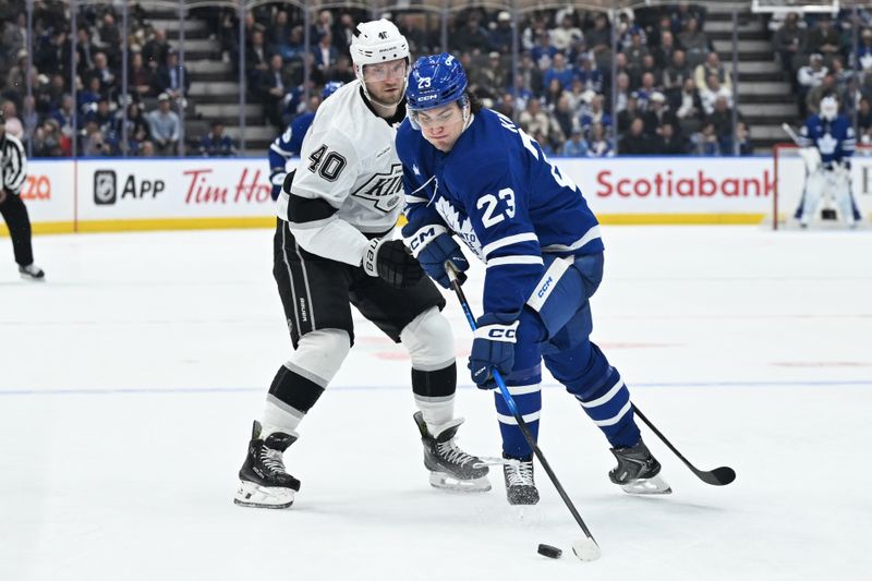 Nov 13, 2025; Toronto, Ontario, CAN;  Toronto Maple Leafs forward Matthew Knies (23) moves the puck past Los Angeles Kings forward Joel Armia (40) in the third period at Scotiabank Arena. Mandatory Credit: Dan Hamilton-Imagn Images