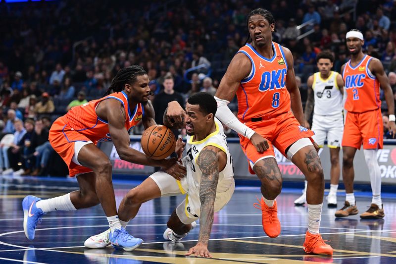 OKLAHOMA CITY, OKLAHOMA - DECEMBER 3: John Collins #20 of the Utah Jazz goes down while handling the ball in front of Cason Wallace #22 of the Oklahoma City Thunder during the first half at Paycom Center on December 3, 2024 in Oklahoma City, Oklahoma. NOTE TO USER: User expressly acknowledges and agrees that, by downloading and or using this photograph, User is consenting to the terms and conditions of the Getty Images License Agreement. (Photo by Joshua Gateley/Getty Images)