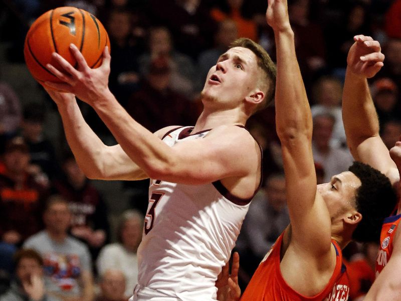 Jan 10, 2024; Blacksburg, Virginia, USA; Virginia Tech Hokies guard Sean Pedulla (3) shoots the ball against Clemson Tigers guard Chase Hunter (1) during the second half at Cassell Coliseum. Mandatory Credit: Peter Casey-USA TODAY Sports