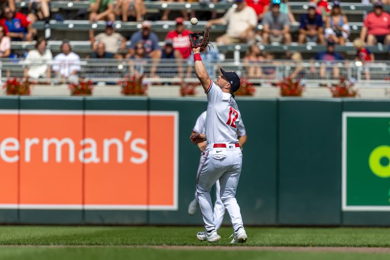 Aug 16, 2023; Minneapolis, Minnesota, USA; Minnesota Twins shortstop Kyle Farmer (12) catches a fly ball against the Detroit Tigers in the eighth inning at Target Field. Mandatory Credit: Jesse Johnson-USA TODAY Sports