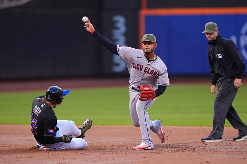 May 21, 2023; New York City, New York, USA; Cleveland Guardians shortstop Gabriel Arias (13) burns a double play with New York Mets third baseman Brett Baty (22) sliding into second base  during the third inning at Citi Field. Mandatory Credit: Gregory Fisher-USA TODAY Sports