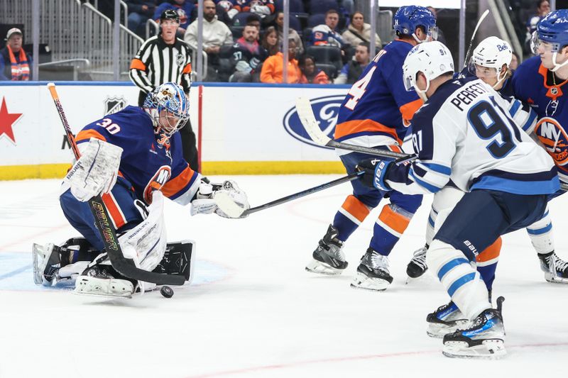 Mar 4, 2025; Elmont, New York, USA;  New York Islanders goaltender Ilya Sorokin (30) makes a save on a shot on goal attempt from Winnipeg Jets center Cole Perfetti (91 )in the third period at UBS Arena. Mandatory Credit: Wendell Cruz-Imagn Images