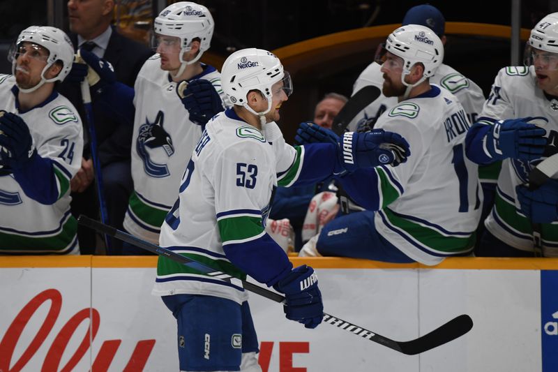 Dec 19, 2023; Nashville, Tennessee, USA; Vancouver Canucks center Teddy Blueger (53) is congratulated by teammates after a goal during the third period against the Nashville Predators at Bridgestone Arena. Mandatory Credit: Christopher Hanewinckel-USA TODAY Sports