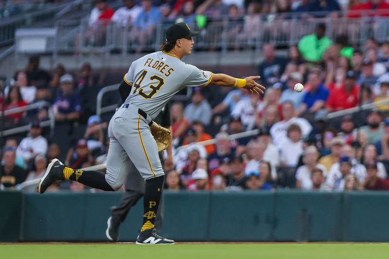 Sep 27, 2025; Cumberland, Georgia, USA; Pittsburgh Pirates catcher Rafael Flores (43) tosses the ball to first base for an out against the Atlanta Braves during the first inning at Truist Park. Mandatory Credit: Jordan Godfree-Imagn Images
