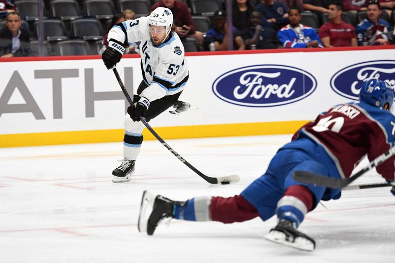 Sep 29, 2024; Denver, Colorado, USA; Utah Hockey Club forward Michael Carcone (53) shoots the puck during the first period against the Colorado Avalanche at Ball Arena. Mandatory Credit: Christopher Hanewinckel-Imagn Images