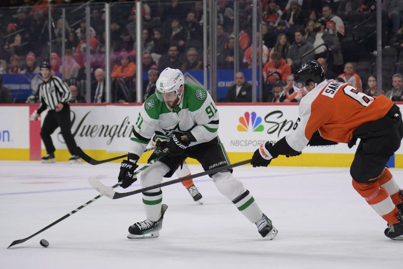 Jan 18, 2024; Philadelphia, Pennsylvania, USA; Dallas Stars center Tyler Seguin (91) battle for the puck with Philadelphia Flyers defenseman Travis Sanheim (6) during the second period at Wells Fargo Center. Mandatory Credit: Eric Hartline-USA TODAY Sports