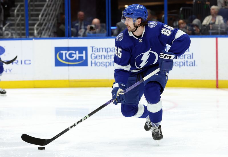 Jan 27, 2024; Tampa, Florida, USA; Tampa Bay Lightning defenseman Maxwell Crozier (65) skates with the puck against the New Jersey Devils during the second period at Amalie Arena. Mandatory Credit: Kim Klement Neitzel-USA TODAY Sports