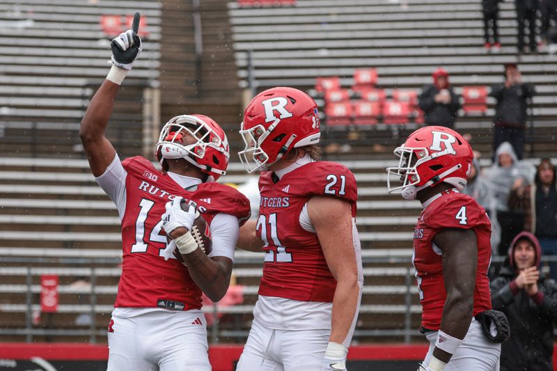 Oct 14, 2023; Piscataway, New Jersey, USA; Rutgers Scarlet Knights wide receiver Isaiah Washington (14) celebrates after a touchdown reception with tight end Johnny Langan (21) and running back Aaron Young (4) during the second half against the Michigan State Spartans at SHI Stadium. Mandatory Credit: Vincent Carchietta-USA TODAY Sports