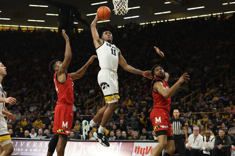 Jan 15, 2023; Iowa City, Iowa, USA; Iowa Hawkeyes guard Tony Perkins (11) drives to the basket against the Maryland Terrapins at Carver-Hawkeye Arena.  The Hawkeyes beat the Terrapins 81 to 67. Mandatory Credit: Reese Strickland-USA TODAY Sports