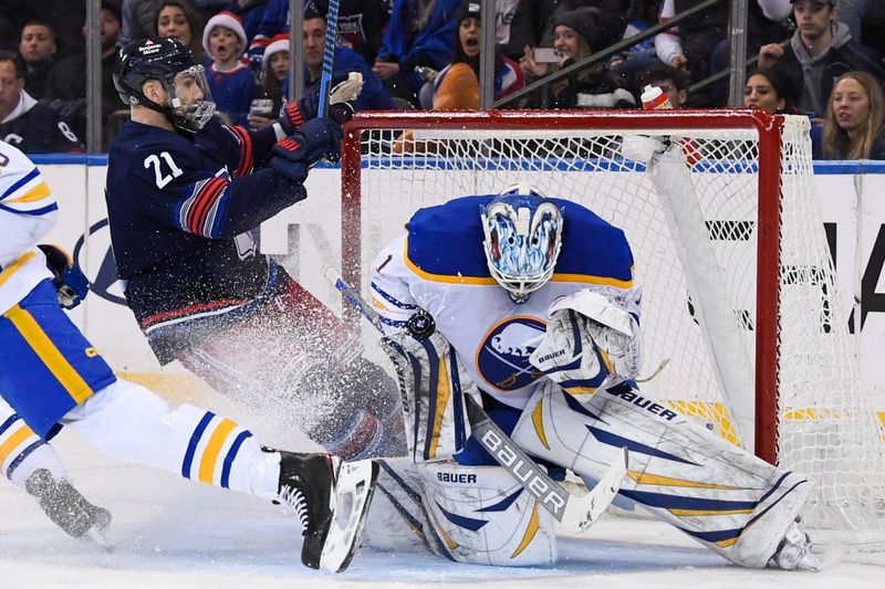 Dec 23, 2023; New York, New York, USA; New York Rangers center Barclay Goodrow (21) slides into Buffalo Sabres goaltender Ukko-Pekka Luukkonen (1) during the third period at Madison Square Garden. Mandatory Credit: Dennis Schneidler-USA TODAY Sports