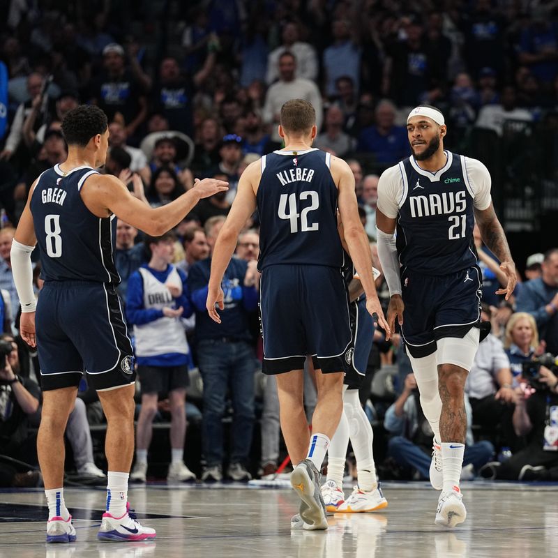 DALLAS, TX - APRIL 26: Josh Green #8, Maxi Kleber #42, and Daniel Gafford #21 of the Dallas Mavericks high five during the game against the LA Clippers during Round 1 Game 3 of the 2024 NBA Playoffs on April 26, 2024 at the American Airlines Center in Dallas, Texas. NOTE TO USER: User expressly acknowledges and agrees that, by downloading and or using this photograph, User is consenting to the terms and conditions of the Getty Images License Agreement. Mandatory Copyright Notice: Copyright 2023 NBAE (Photo by Glenn James/NBAE via Getty Images)