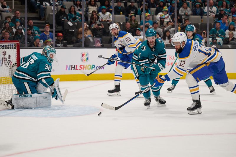 Jan 27, 2024; San Jose, California, USA; Buffalo Sabres left wing Jordan Greenway (12) shoots the puck against San Jose Sharks goaltender Kaapo Kahkonen (36) and defenseman Kyle Burroughs (4) during the first period at SAP Center at San Jose. Mandatory Credit: Robert Edwards-USA TODAY Sports