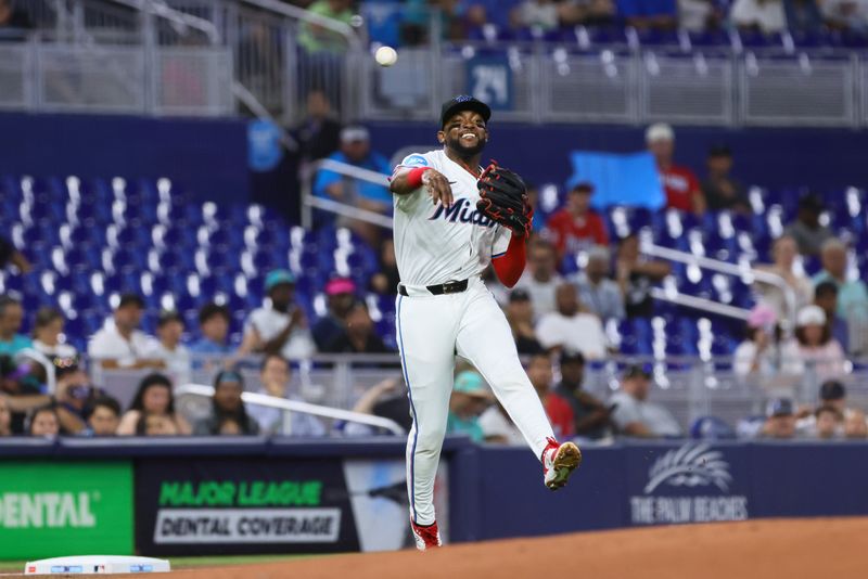 Jun 5, 2024; Miami, Florida, USA; Miami Marlins third baseman Vidal Brujan (17) throws to first base to retire Tampa Bay Rays first baseman Yandy Diaz (not pictured) during the first inning at loanDepot Park. Mandatory Credit: Sam Navarro-USA TODAY Sports