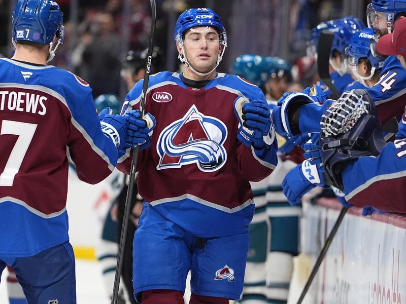 Nov 26, 2025; Denver, Colorado, USA; Colorado Avalanche center Ross Colton (20) celebrates with teammates after scoring a goal against the San Jose Sharks in the first period at Ball Arena. Mandatory Credit: Ron Chenoy-Imagn Images