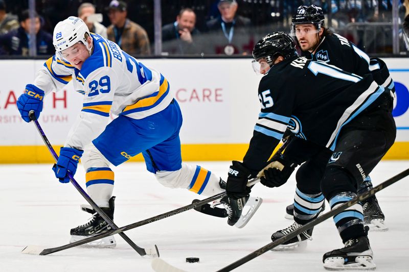 Jan 9, 2026; Salt Lake City, Utah, USA; Utah Mammoth center Alexander Kerfoot (15) barely gets his stick in the way of a shot by St. Louis Blues right wing Jonatan Berggren (29) during first period at Delta Center. Mandatory Credit: Peter Creveling-Imagn Images