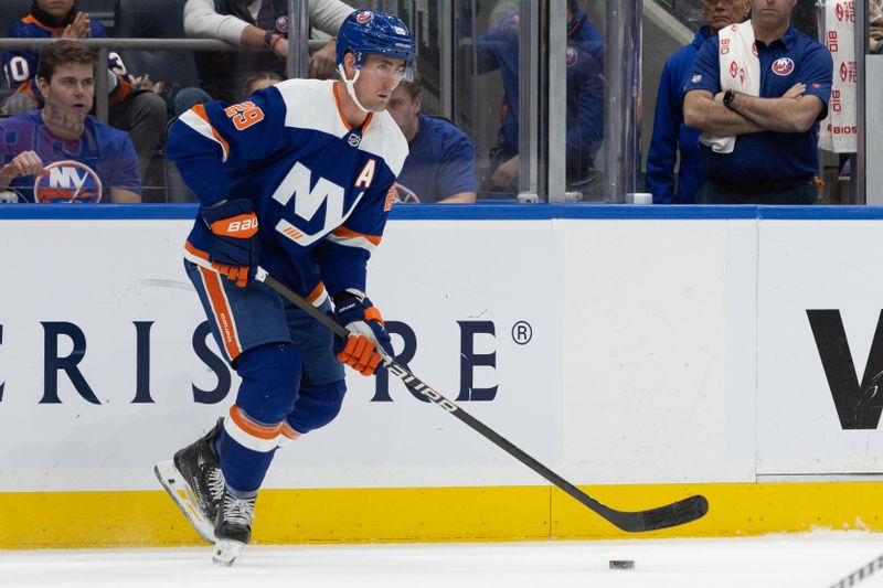 Nov 25, 2023; Elmont, New York, USA; New York Islanders center Brock Nelson (29) look to move the puck against the Philadelphia Flyers during the second period at UBS Arena. Mandatory Credit: Thomas Salus-USA TODAY Sports