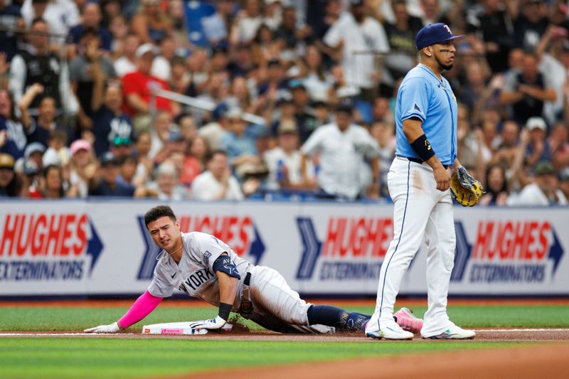 May 12, 2024; St. Petersburg, Florida, USA;  New York Yankees shortstop Anthony Volpe (11) slides into third base after hitting a triple against the Tampa Bay Rays in the first inning at Tropicana Field. Mandatory Credit: Nathan Ray Seebeck-USA TODAY Sports