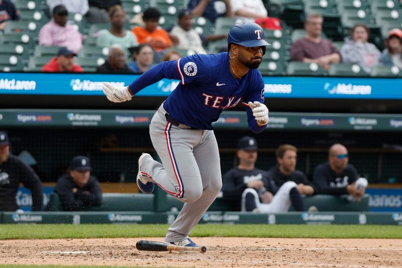 Apr 17, 2024; Detroit, Michigan, USA; Texas Rangers first baseman Ezequiel Duran (20) hits a single during the ninth inning against the Detroit Tigers at Comerica Park. Mandatory Credit: Brian Bradshaw Sevald-USA TODAY Sports