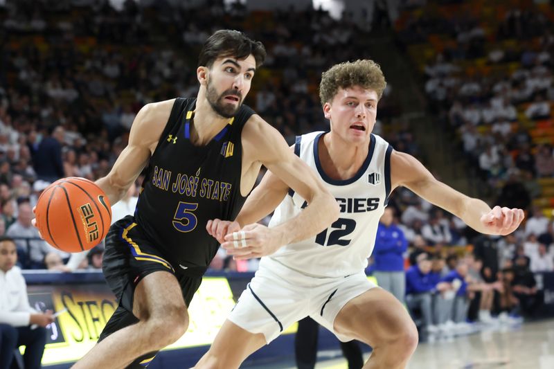 Jan 30, 2024; Logan, Utah, USA; San Jose State Spartans forward Tibet Gorener (5) drives to the basket against Utah State Aggies guard Mason Falslev (12) during the first half at Dee Glen Smith Spectrum. Mandatory Credit: Rob Gray-USA TODAY Sports