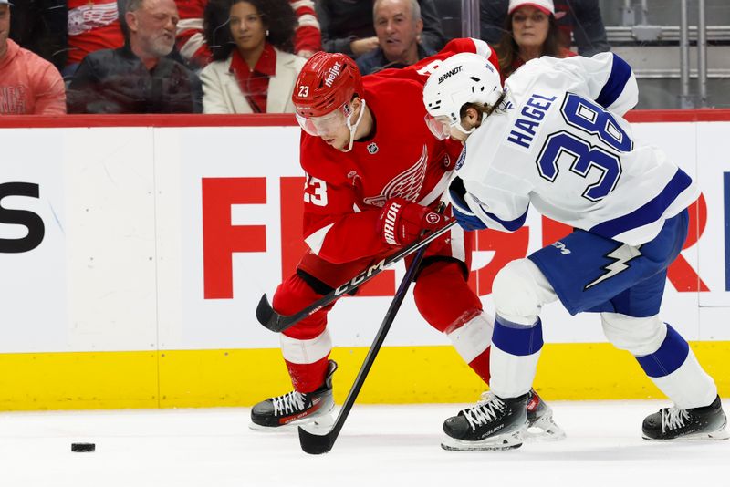 Jan 25, 2025; Detroit, Michigan, USA;  Detroit Red Wings left wing Lucas Raymond (23) and Tampa Bay Lightning left wing Brandon Hagel (38) battle for the puck in the second period at Little Caesars Arena. Mandatory Credit: Rick Osentoski-Imagn Images