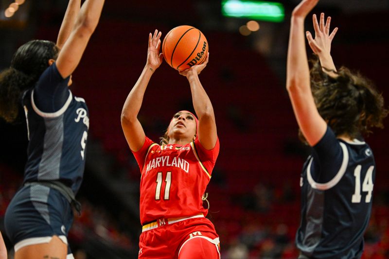 Feb 18, 2024; College Park, Maryland, USA;  Maryland Terrapins guard Jakia Brown-Turner (11) shoots in-between Penn State Nittany Lions defenders during the second  half at Xfinity Center. Mandatory Credit: Tommy Gilligan-USA TODAY Sports