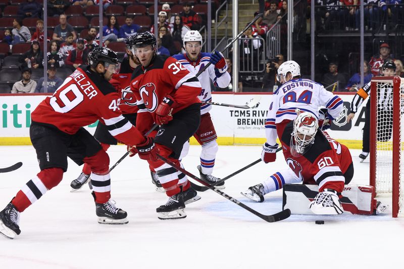 Sep 30, 2024; Newark, New Jersey, USA; New Jersey Devils goaltender Jeremy Brodeur (60) makes a save against the New York Rangers during the third period at Prudential Center. Mandatory Credit: Ed Mulholland-Imagn Images