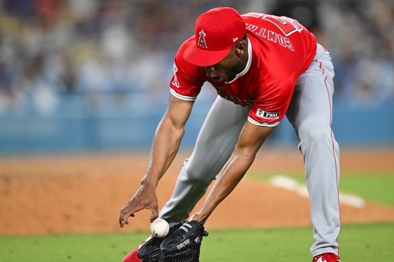 Jun 22, 2024; Los Angeles, California, USA; Los Angeles Angels pitcher Roansy Contreras (57) catches a short ball against the Los Angeles Dodgers during the eighth inning at Dodger Stadium. Mandatory Credit: Jonathan Hui-USA TODAY Sports