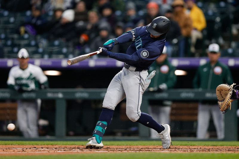 Apr 20, 2024; Denver, Colorado, USA; Seattle Mariners left fielder Jonatan Clase (5) hits a 3 RBI single on a Colorado Rockies error in the fifth inning at Coors Field. Mandatory Credit: Isaiah J. Downing-USA TODAY Sports