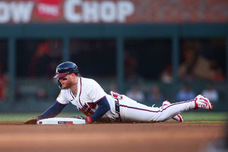 May 12, 2025; Atlanta, Georgia, USA; Atlanta Braves left fielder Alex Verdugo (8) slides into second safely with a double against the Washington Nationals in the first inning at Truist Park. Mandatory Credit: Brett Davis-Imagn Images
