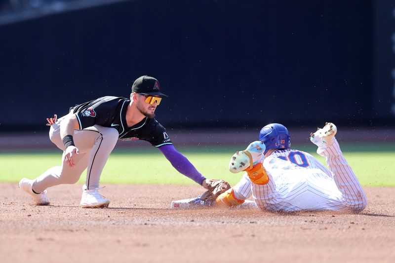 Jun 1, 2024; New York City, New York, USA; New York Mets first baseman Pete Alonso (20) slides into second base for a double ahead of the tag by Arizona Diamondbacks second baseman Blaze Alexander (9) during the first inning at Citi Field. Mandatory Credit: Brad Penner-USA TODAY Sports